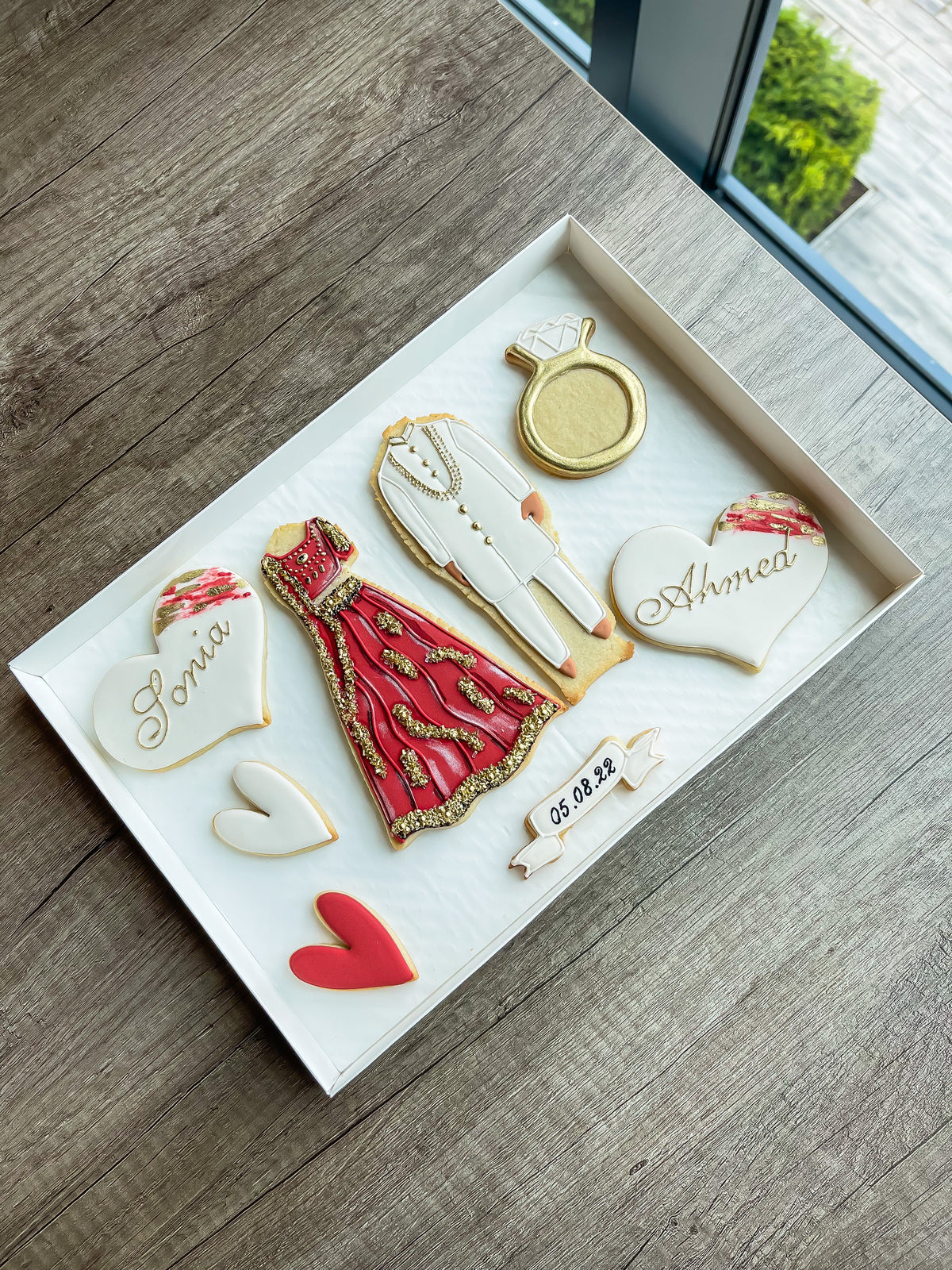 Personalised wedding sugar cookie gift box with a car, flowers and names by Reet Petite Bakery Co