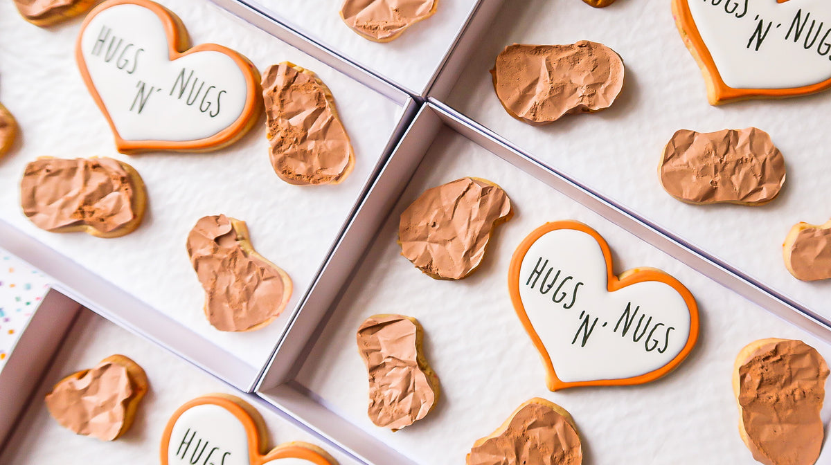 Hugs N Nugs branded sugar cookie gift boxes made by Reet Petite Bakery Co