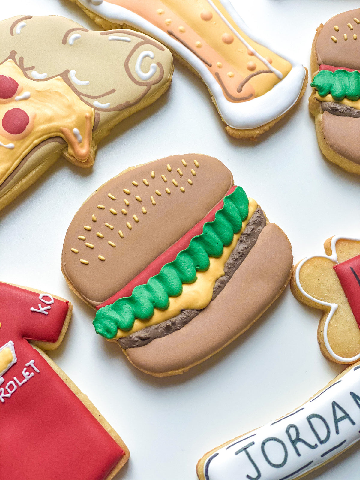 Playful burger and pizza sugar cookies handmade by Reet Petite Bakery Co